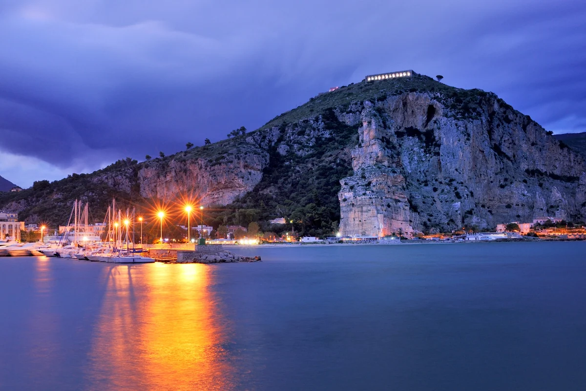 The harbour of Terracina in the evening, with the Temple of Jupiter Anxur on the promontory.